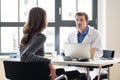 Young physician listening to his patient with respect and dedica Royalty Free Stock Photo