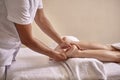 Young physiotherapist massage woman feet, hands close up.