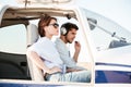 Young pilot and beautiful stewardess sitting inside airplane cabin Royalty Free Stock Photo