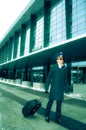 Young pilot walking with baggage in Kastrup airpor