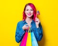 Girl holding a colored shopping bags and USA flag Royalty Free Stock Photo