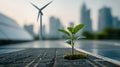 Young plant growing among solar panels and wind turbines in urban setting Royalty Free Stock Photo