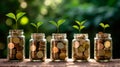 Young plants growing from coins in several savings jars, saving money for future, alternative investments and sustainability Royalty Free Stock Photo