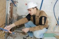 Young plasterer worker at indoors wall insulation works Royalty Free Stock Photo