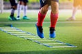 Young player exercises on ladder drills. Royalty Free Stock Photo