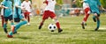 Young Players in Soccer Game. Boy Kicking Soccer Ball Towards Goal Royalty Free Stock Photo