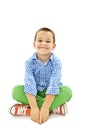 A young playful boy sitting on the floor