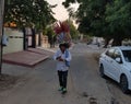 A young boy is playing flute for selling flutes in India