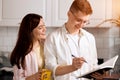 Young pleasant family counting callories Royalty Free Stock Photo