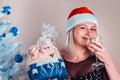 Young pleasant happy woman with glass of champagne in hand and pig toy gift
