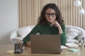 Young pleasant Italian woman freelancer working on laptop computer remotely at home Royalty Free Stock Photo