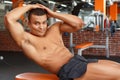 Young pleasant man doing abdominal crunches in gym Royalty Free Stock Photo