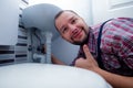 Plumber Fixing a Sink In Bathroom