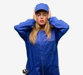 Young woman with plumber clothes isolated over grey background Royalty Free Stock Photo