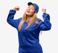 Young woman with plumber clothes isolated over grey background