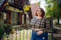 young plus size argentinian woman standing outside the house looking at the camera