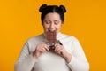 Young Plus Size Girl Enjoying Eating Chocolate Bar Royalty Free Stock Photo