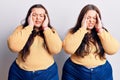 Young plus size twins wearing casual clothes with hand on head, headache because stress Royalty Free Stock Photo