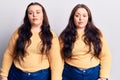 Young plus size twins wearing casual clothes looking sleepy and tired, exhausted for fatigue and hangover, lazy eyes in the
