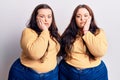 Young plus size twins wearing casual clothes thinking looking tired and bored with depression problems with crossed arms