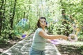 Young plus size woman blowing soap bubbles