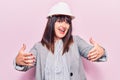 Young plus size woman wearing architect hardhat looking at the camera smiling with open arms for hug Royalty Free Stock Photo