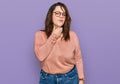 Young plus size woman wearing casual clothes and glasses touching painful neck, sore throat for flu, clod and infection