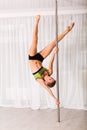 Young pole dancer in the studio Royalty Free Stock Photo