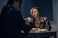 A young police officer is interrogating a girl suspected of distributing drugs