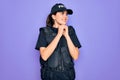 Young police woman wearing security bulletproof vest uniform over purple background laughing nervous and excited with hands on Royalty Free Stock Photo