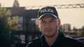 young policeman in cap with police