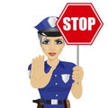 Young policewoman holding stop sign and showing stop gesture