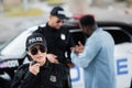 Young policewoman talking on radio set