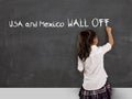 Young political activist schoolgirl writing on school classroom blackboard Mexico and USA wall off Royalty Free Stock Photo