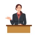 Young politician woman standing behind rostrum and giving a speec