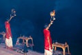 Young poojari perform fire ritual of worshipping on the bank of Ganges river in Rishikesh Royalty Free Stock Photo