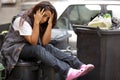 Young poor girl in bin