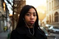 Young portrait of long hair African woman with soft sunlight street city background