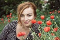 Young positive caucasian woman and corn poppy flowers, beauty an Royalty Free Stock Photo