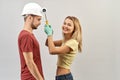 Young positive couple fooling around during the repair and paint Royalty Free Stock Photo