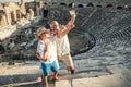 Young positive family take a self photo on the antique amphitheater in Side, Turkey Royalty Free Stock Photo