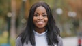 Young positive girl turns looking at camera businesswoman smiling with white teeth attractive happy african american Royalty Free Stock Photo