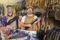 Young guys in military equipment with rifle in airsoft shop