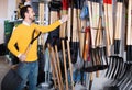 Man choosing new shovel in garden equipment shop Royalty Free Stock Photo