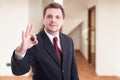 Young positive realtor showing ok sign