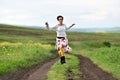 Young positive woman running on a countryside road Royalty Free Stock Photo