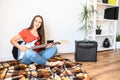 Young woman plays electric guitar at home Royalty Free Stock Photo