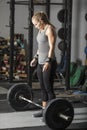 Young powerful woman preparing for deadlift