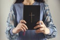 Young prayer woman holding Bible