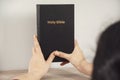 Young prayer woman holding Bible